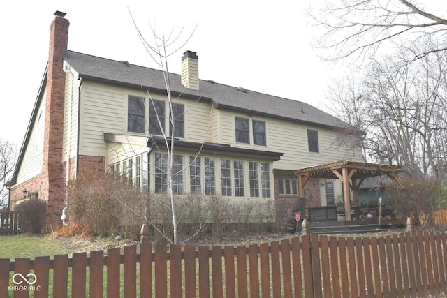 rear view of house featuring a pergola