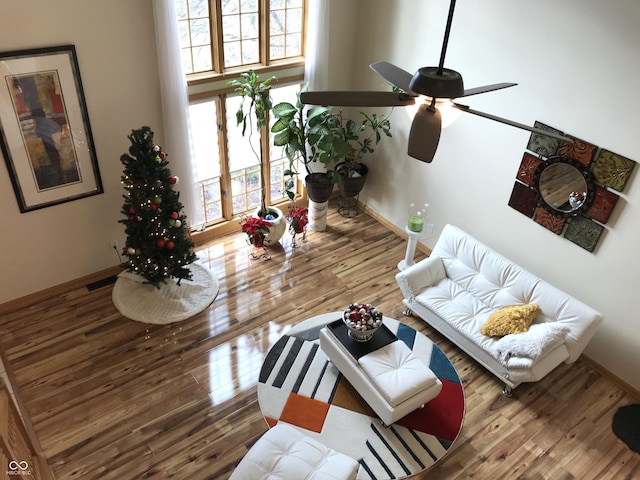 living room featuring ceiling fan and wood-type flooring