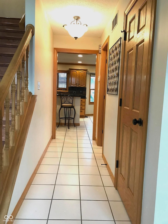 hallway with light tile patterned floors