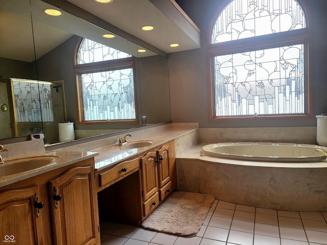 bathroom with tile patterned floors, vanity, independent shower and bath, and a wealth of natural light