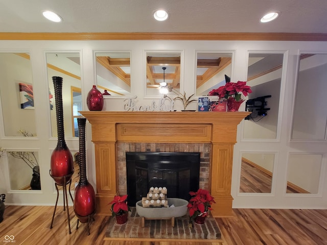 interior details with crown molding, wood-type flooring, and a fireplace