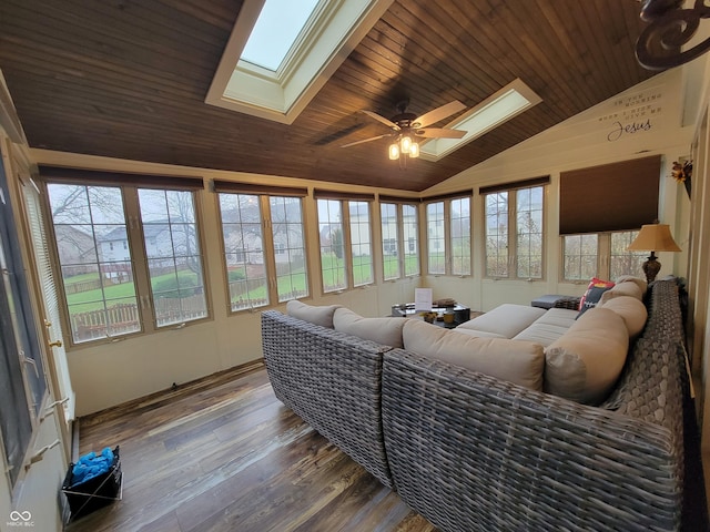 living room with hardwood / wood-style floors, vaulted ceiling with skylight, ceiling fan, and wood ceiling