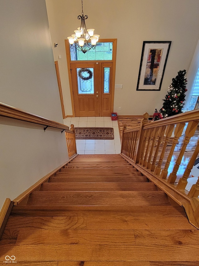 foyer with a chandelier and hardwood / wood-style flooring