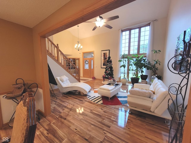 living room featuring hardwood / wood-style floors and ceiling fan with notable chandelier