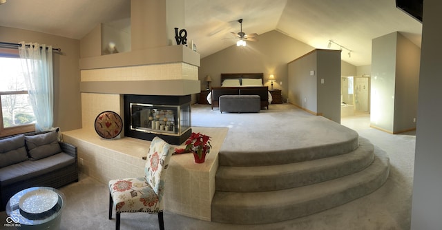 carpeted bedroom featuring ensuite bath, ceiling fan, a multi sided fireplace, and vaulted ceiling