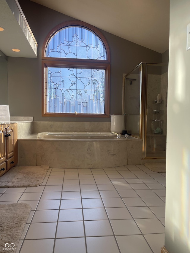 bathroom with tile patterned floors, plenty of natural light, lofted ceiling, and shower with separate bathtub