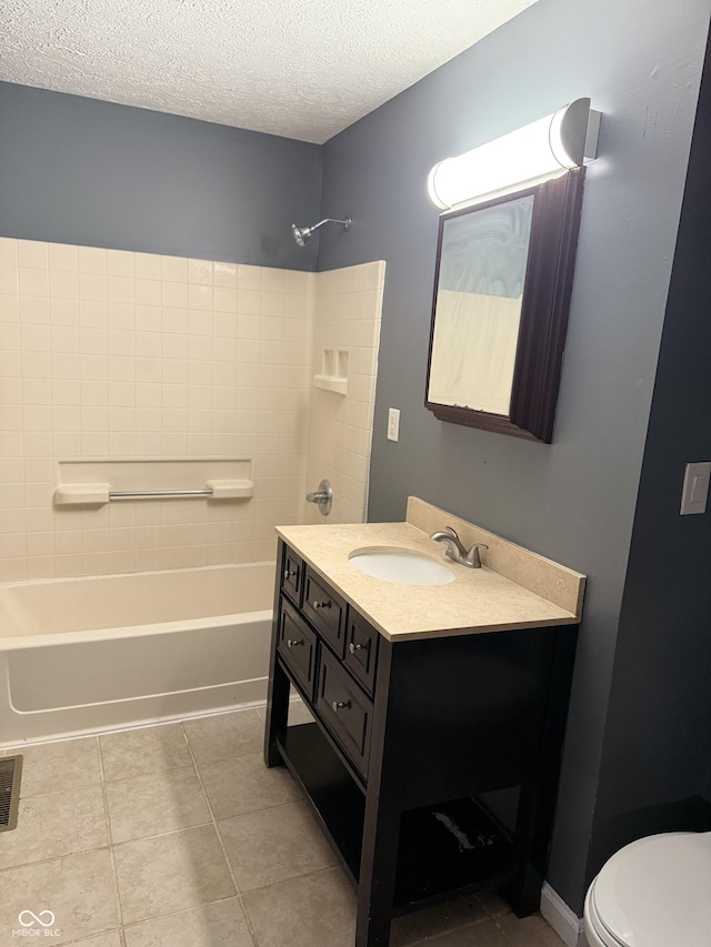 full bathroom featuring tile patterned floors, tub / shower combination, a textured ceiling, vanity, and toilet