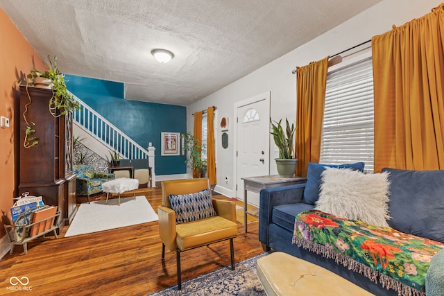 living room with wood-type flooring and a textured ceiling