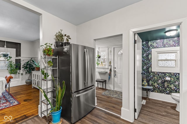 kitchen featuring stainless steel refrigerator and dark hardwood / wood-style floors