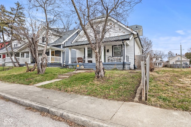 bungalow-style house featuring a porch and a front lawn