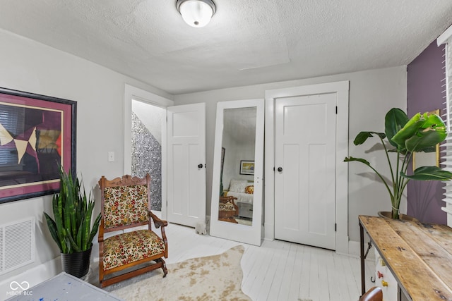 sitting room with a textured ceiling