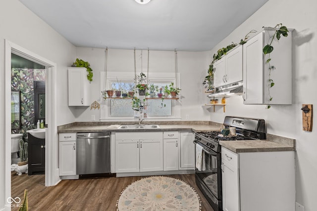 kitchen with gas stove, white cabinetry, dishwasher, sink, and dark hardwood / wood-style flooring