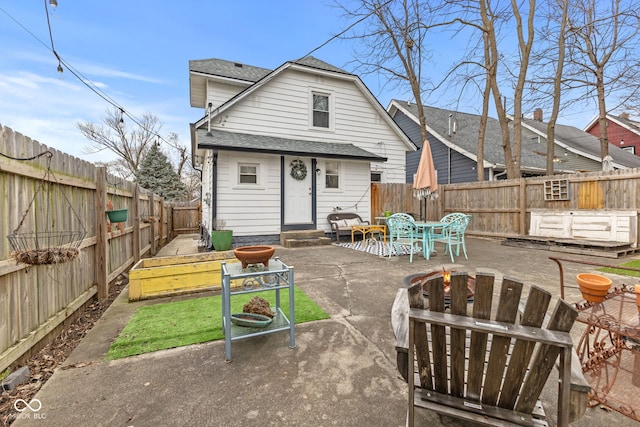 back of house with a patio