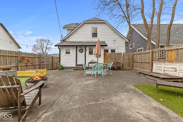 back of property featuring a patio area and an outdoor fire pit