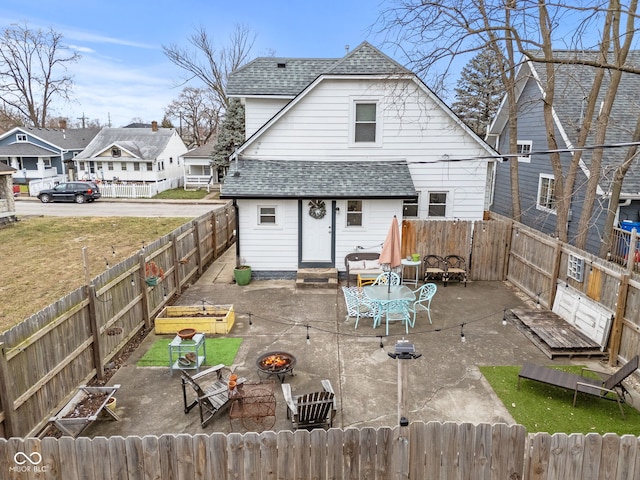 back of house featuring a fire pit and a patio