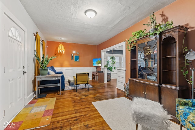 interior space featuring a textured ceiling and hardwood / wood-style flooring