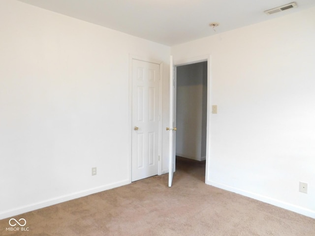 empty room featuring light colored carpet