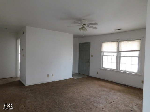 empty room featuring carpet flooring and ceiling fan