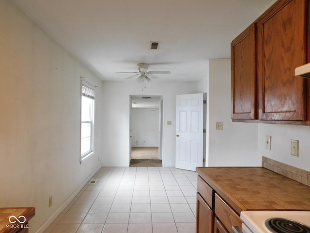 kitchen with light tile patterned floors and ceiling fan