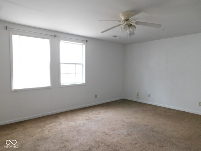 spare room featuring ceiling fan and carpet