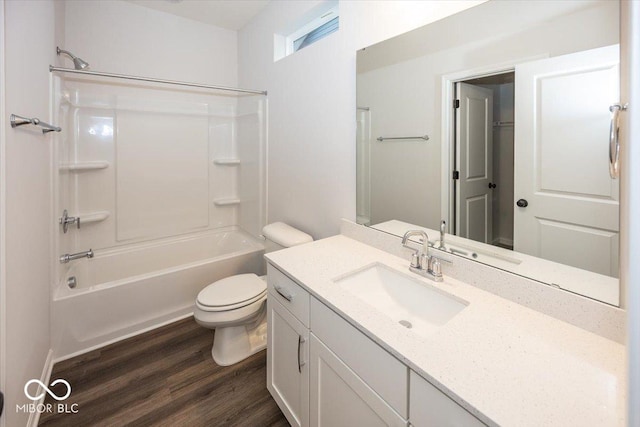 full bathroom with hardwood / wood-style floors, vanity, toilet, and washtub / shower combination