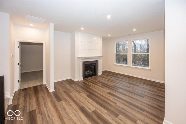 unfurnished living room featuring dark hardwood / wood-style floors