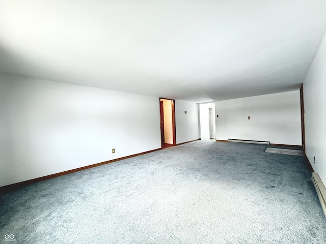 carpeted empty room featuring a baseboard radiator and baseboards