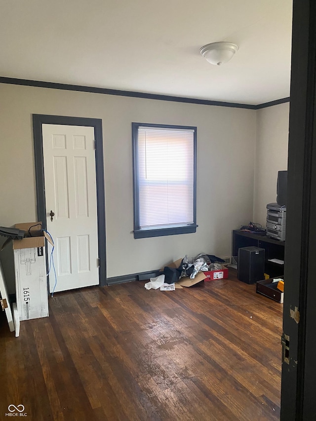 interior space with dark hardwood / wood-style flooring and crown molding