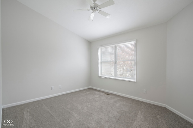 carpeted empty room featuring ceiling fan