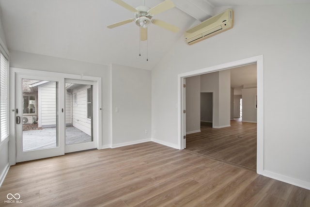 spare room featuring vaulted ceiling with beams, hardwood / wood-style flooring, an AC wall unit, and ceiling fan