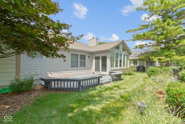 rear view of property featuring a yard