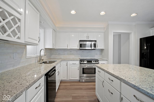 kitchen with black appliances, light hardwood / wood-style floors, white cabinets, and sink