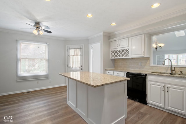 kitchen featuring white cabinets, dishwasher, pendant lighting, and sink