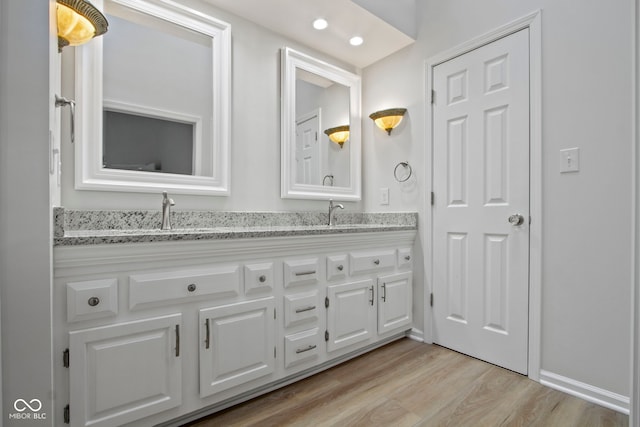 bathroom with vanity and wood-type flooring