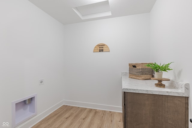 clothes washing area featuring light wood-type flooring and electric dryer hookup