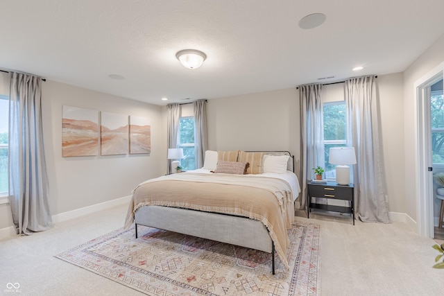 carpeted bedroom with a textured ceiling