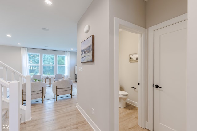 hallway with light hardwood / wood-style flooring