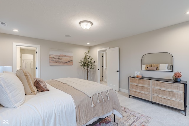 carpeted bedroom with ensuite bathroom