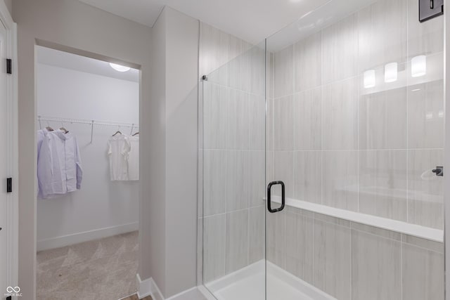 bathroom featuring a shower with shower door