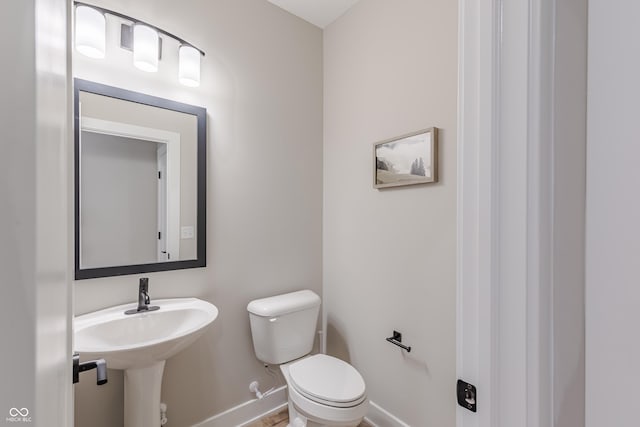 bathroom featuring toilet and sink