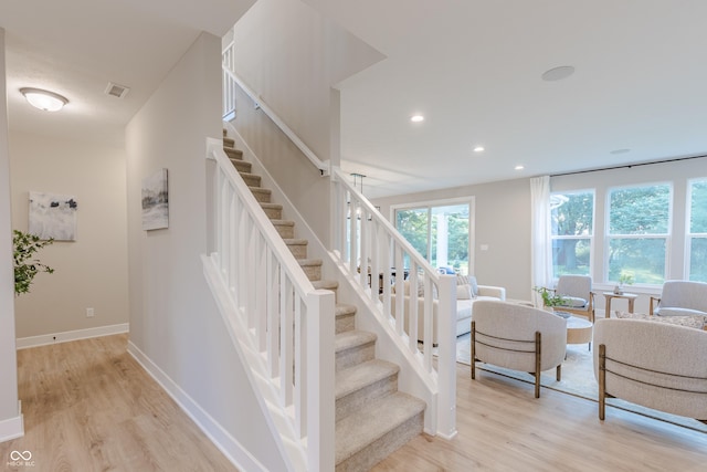 stairs with hardwood / wood-style floors