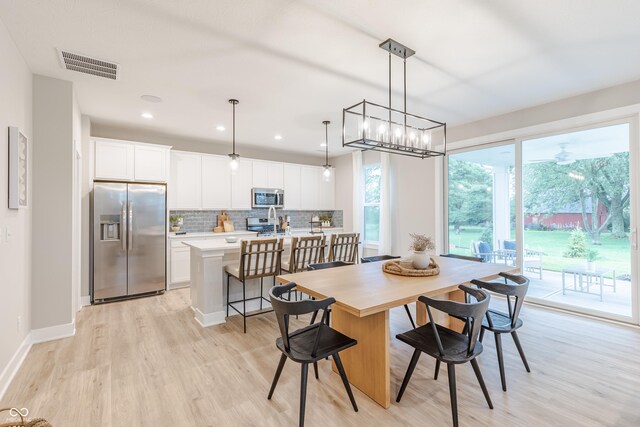 dining area with light hardwood / wood-style floors