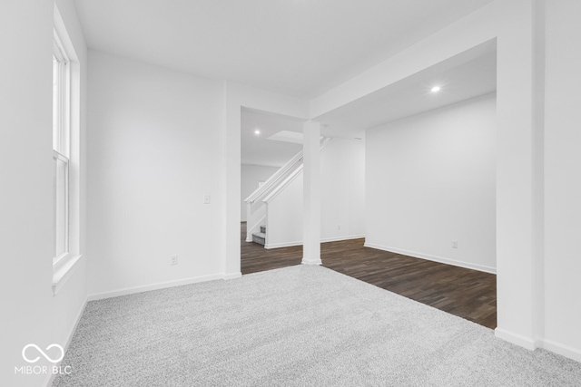 interior space with stairs, baseboards, dark colored carpet, and recessed lighting