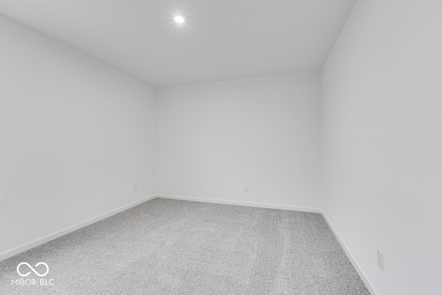 carpeted empty room featuring baseboards and recessed lighting