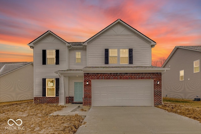 traditional-style home with concrete driveway, brick siding, and an attached garage