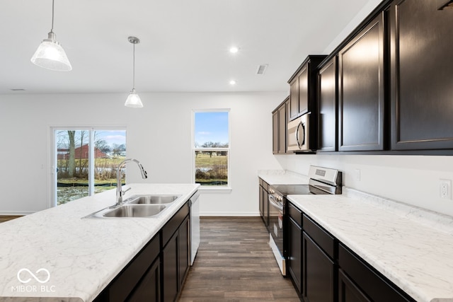 kitchen featuring a wealth of natural light, appliances with stainless steel finishes, pendant lighting, and a sink