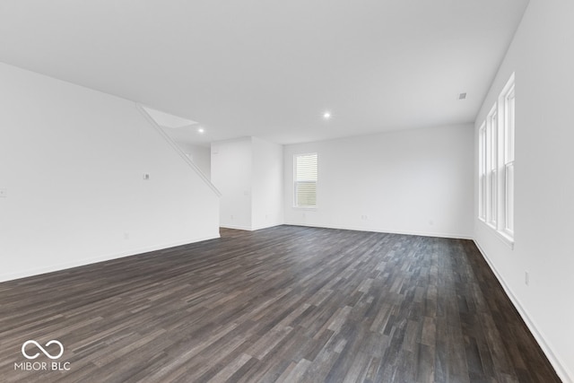 interior space featuring baseboards, dark wood-type flooring, and recessed lighting