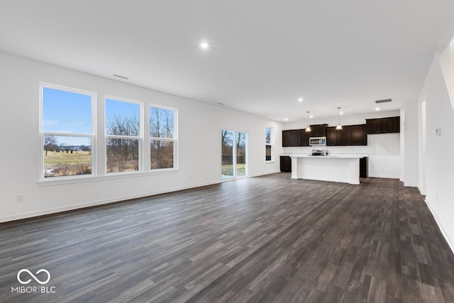 unfurnished living room featuring dark wood-style floors, recessed lighting, visible vents, and baseboards