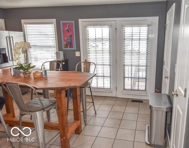 dining room featuring plenty of natural light and light tile patterned floors