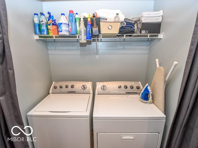 clothes washing area featuring washer and clothes dryer